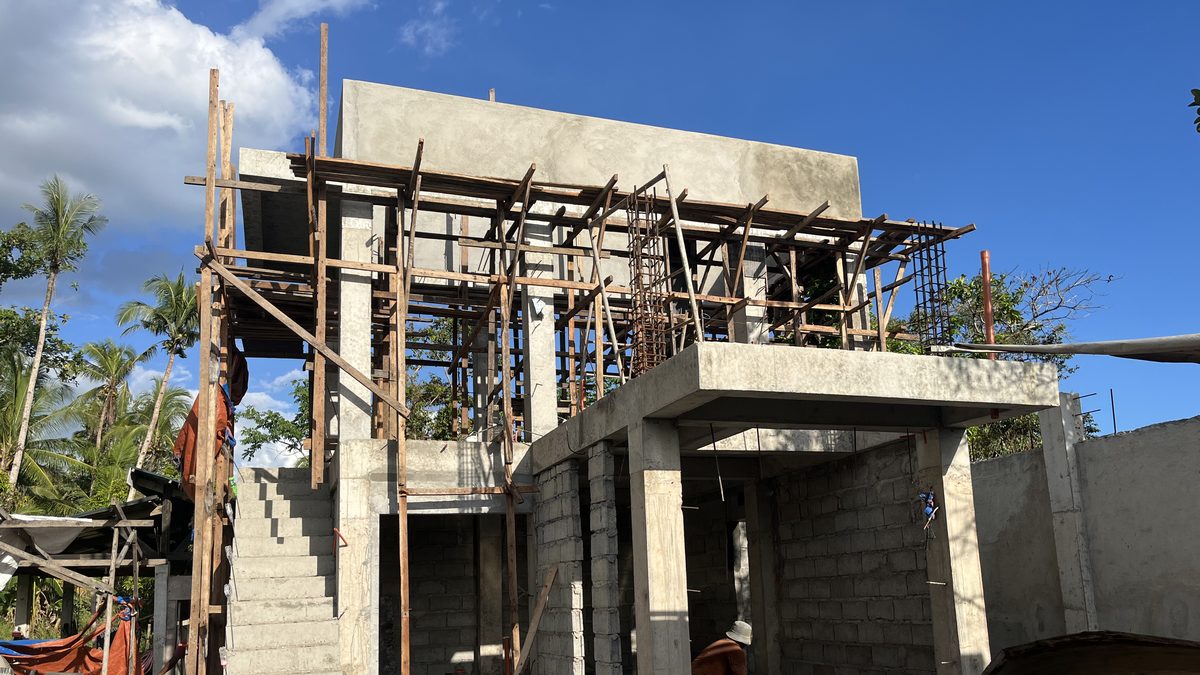 Two-storey structure under construction with formwork and scaffolding
